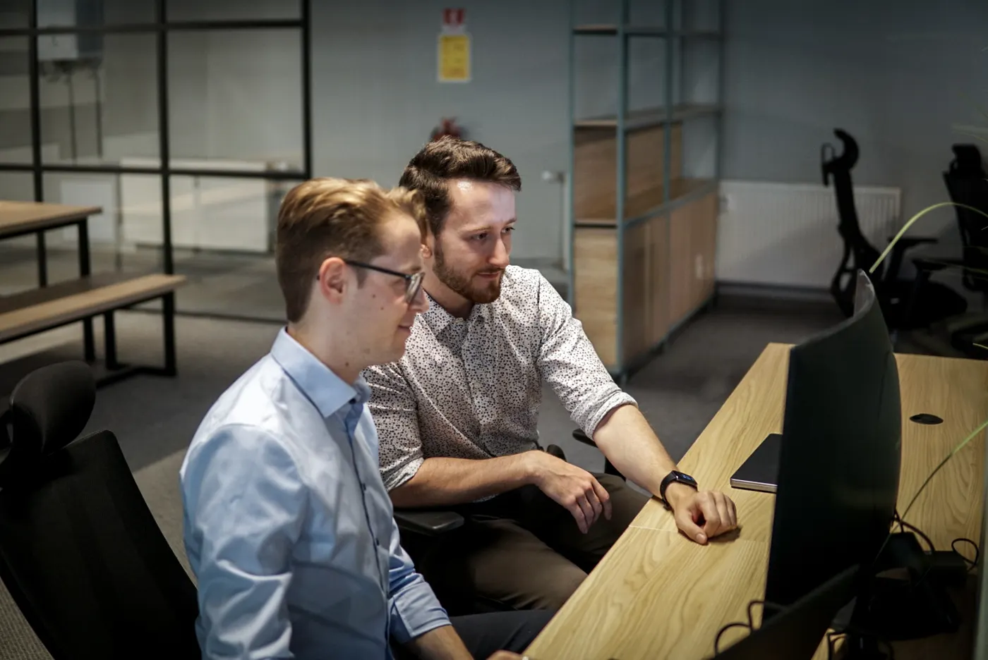 Two twinalps engineers reviewing infrastructure at a shared desk